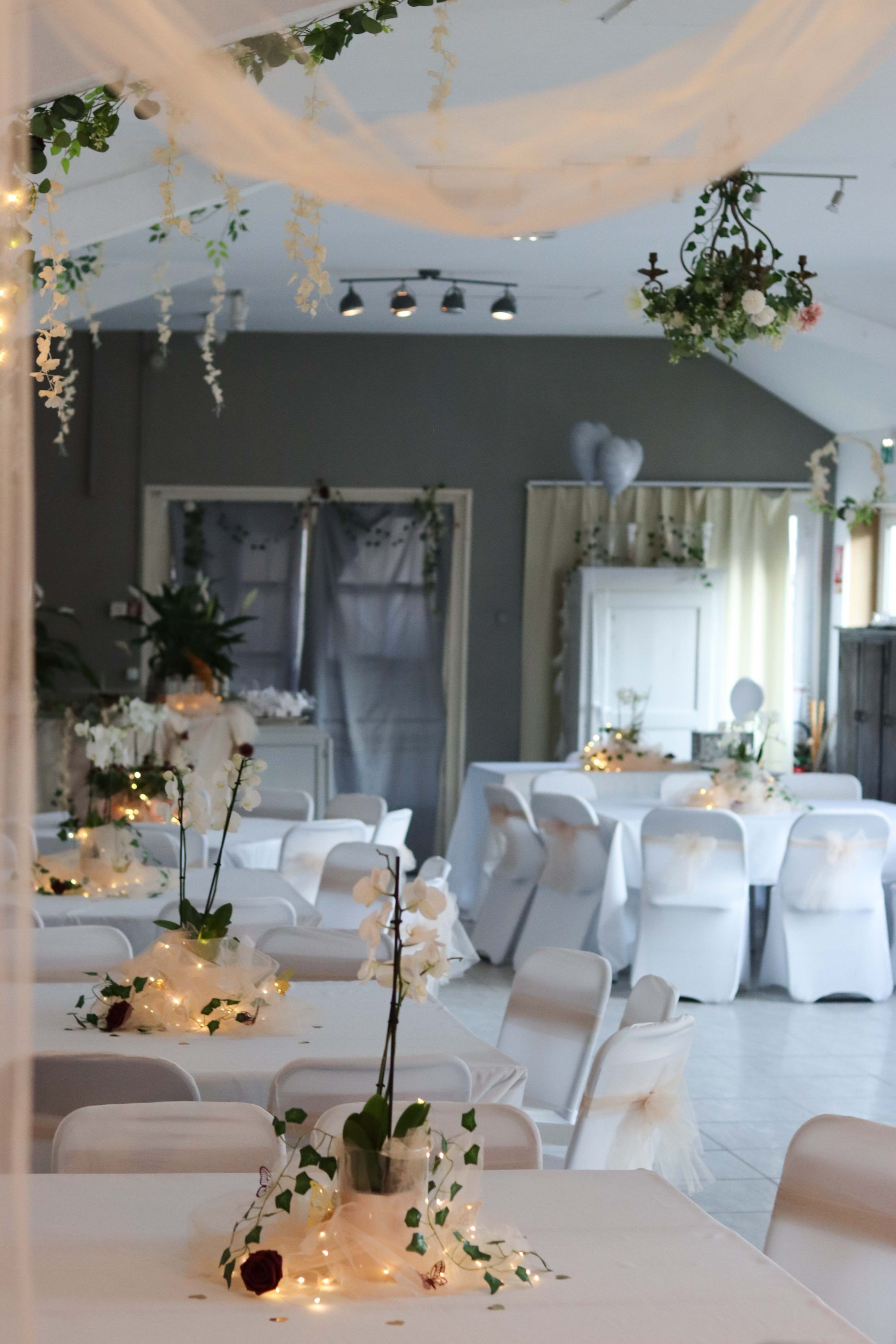Intimate reception space styled with orchids, ivy, and string lights